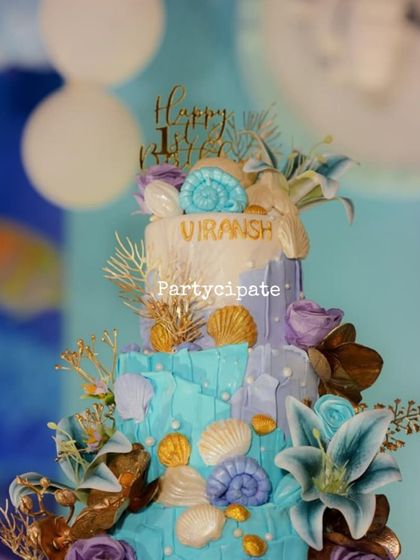 The cake for this under the sea party was a work of art, decorated with beautiful handcrafted shells, coral, and sea flowers.