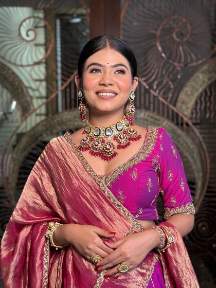 With a plush trail of grace. This look is all about soft, dewy makeup that looks real and unfiltered. The jewel tones of the outfit are simply stunning.