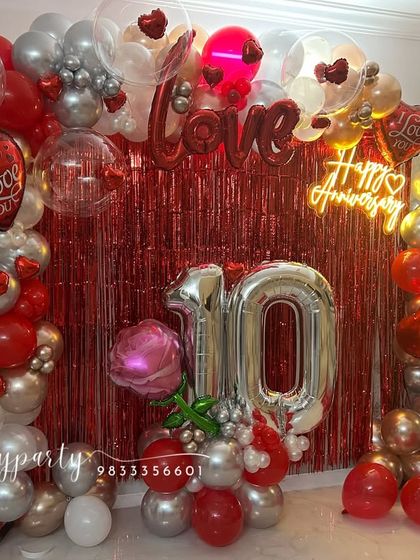 This image captures the full anniversary arrangement in a home living room, showing how our designs can create a complete photo-ready backdrop for your celebration.