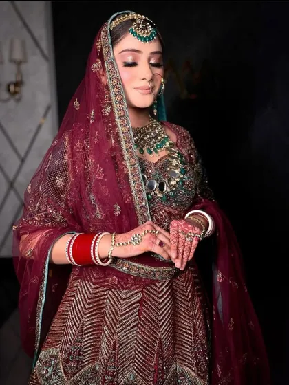 A close-up of the bride's serene expression, with the heavy jewellery adding to her regal aura.