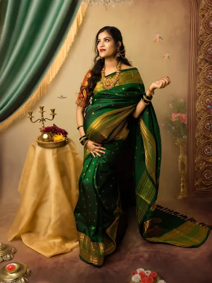 A stunning full-length portrait of the expectant mother. Her pose is confident and graceful, showcasing the beautiful drape of the traditional saree against our painterly backdrop.
