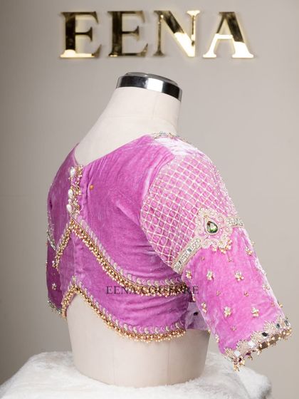 I love blending contemporary design with timeless fabrics. This lavender velvet blouse features a modern jewelry-like embellishment on the sleeves, with a mix of lattice work, pearls, and a central emerald-green stone.