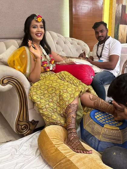 My team and I working on a bride, including her feet mehndi. For large events, we ensure every detail is perfect, providing full coverage for both hands and feet.