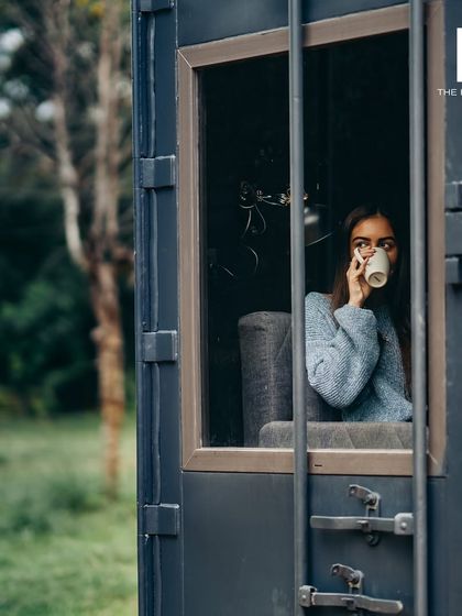 A moment of calm in one of my minimalist container homes. The large window frames the natural surroundings, turning the view into a living piece of art and making the compact space feel open.