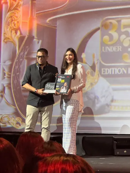 Receiving the 35 Under 35 award on stage. This moment represents years of dedication, creativity, and perseverance in a competitive industry.