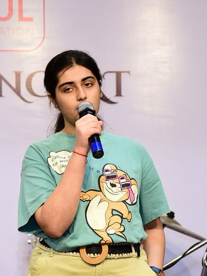 A teenage student sings with emotion at the TMG Student's Concert. Performing helps students connect with their music on a deeper level.