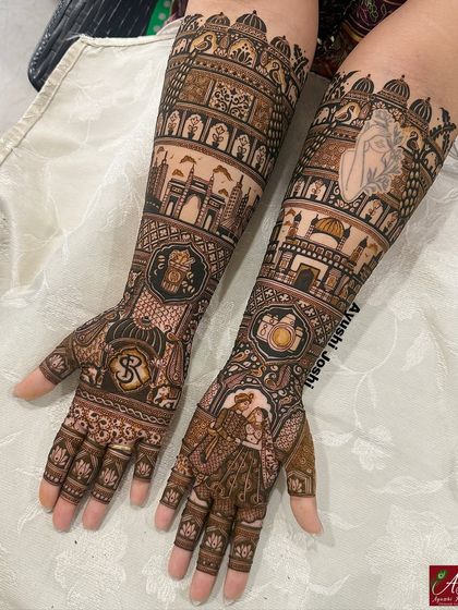 A clearer, brighter shot of the skyline mehendi, highlighting the intricate details of the bride and groom figures and the custom logos.