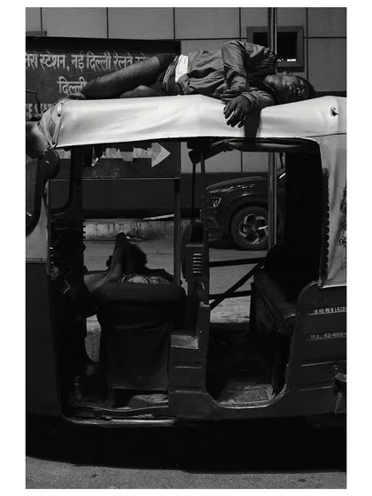 In the dead of night, a man finds rest atop his auto-rickshaw outside a Delhi railway station. It's a quiet, powerful image of resilience and a slice of life from my 24-hour documentary project.