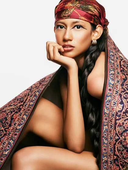 Exploring the intersection of heritage and high fashion. The look combines a traditional head covering and a long, classic braid with a sharp, modern eyeliner to create something new.