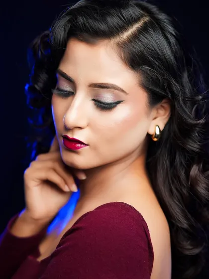 A side profile of the Hollywood glam look, showing the perfectly sculpted waves and the elegant makeup.