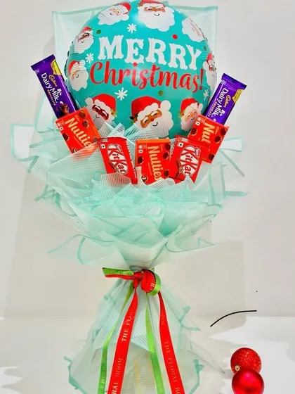 A simple and sweet Christmas chocolate bouquet. This arrangement includes KitKat and Dairy Milk bars topped with a "Merry Christmas" balloon and wrapped in festive green paper.