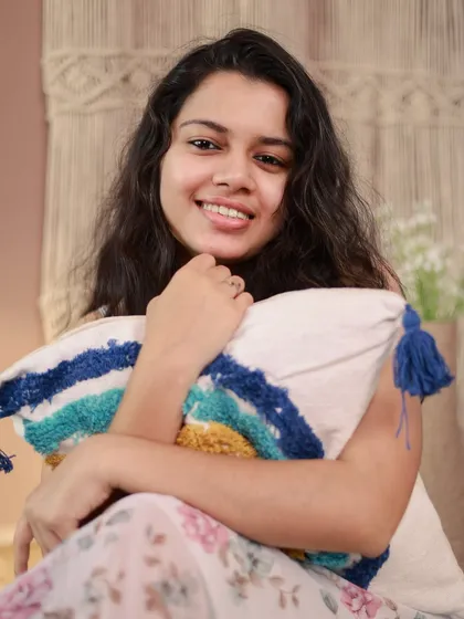 Switching to a softer, boho-inspired setup. This casual, cozy portrait with a textured pillow shows a completely different side of the model's personality.
