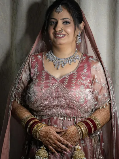 A simple and elegant portrait of the bride, her smile and beautiful jewelry shining through.