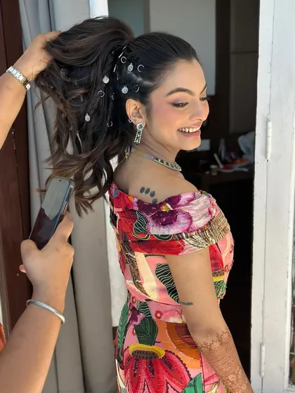 A fun, behind-the-scenes shot of the carnival look. The playful hairstyle with rings and the reverse wing makeup are full of character and carefree spirit.
