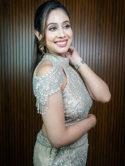 This silver-beige lehenga with a modern cut is perfect for a cocktail party. The cold-shoulder blouse with beaded tassels is very trendy.
