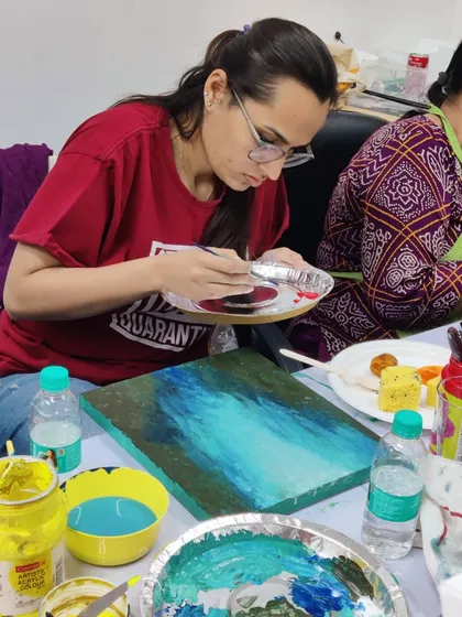 More scenes from our acrylic workshop for doctors, showing the focus and enjoyment as they mix colors and bring their canvases to life.