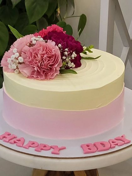Another view of this pretty two-toned cake with fresh flowers. It's perfect for someone who loves a clean and minimalist design for their birthday.