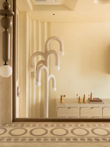 This whimsical floor lamp, reflected in a mirror, adds a playful touch to the home office. Its curved, looping forms are a perfect example of how we like to incorporate sculptural lighting that doubles as art.