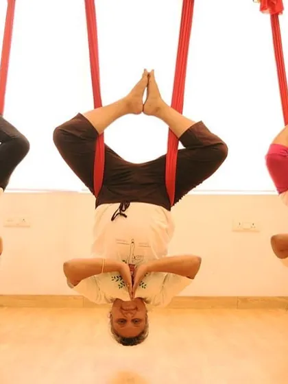 There is a special energy when we practice together. In my small group classes, we create a supportive community where everyone feels comfortable to hang, fly, and laugh. Here, we are all in a synchronized inverted Baddha Konasana, or bound angle pose.