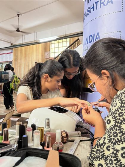 A close-up shot of me working on a client's nails at my college stall. I love interacting with my clients and bringing their ideas to life.