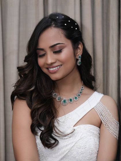 A close-up on the glossy nude perfection. The eyes have a soft wash of color, and the skin is luminous, creating a radiant and polished look.