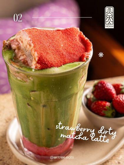 This Strawberry Dirty Matcha Latte is a feast for the eyes. The photo showcases the vibrant layers of green and red, and the strawberry garnish adds texture and freshness. It's a perfect shot for a summer menu.