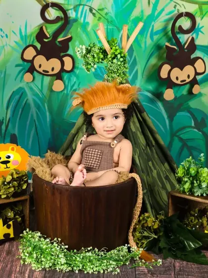 Dressed as a little lion, this baby boy looks adorable and ready for a jungle adventure in his themed photoshoot.