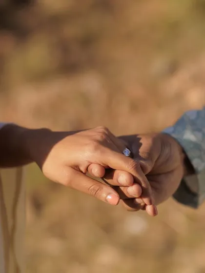 A close-up detail shot of their hands intertwined. This simple image is so powerful, symbolizing their connection and the commitment they are about to make.