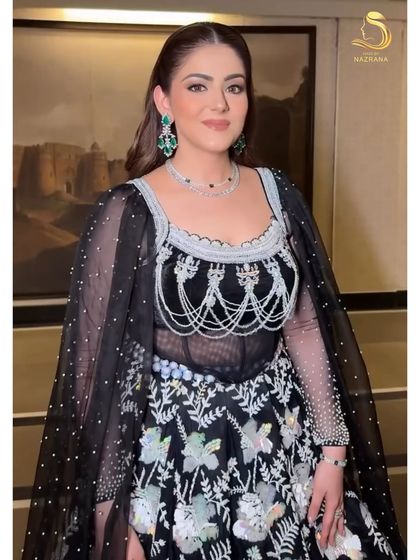 Sculpted sleekness meets flowing finesse. A half-up style with voluminous waves for a cocktail party.