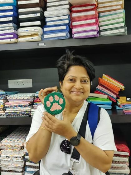 A perfectly executed paw print coaster, showcasing the fluffy texture of punch needle art.