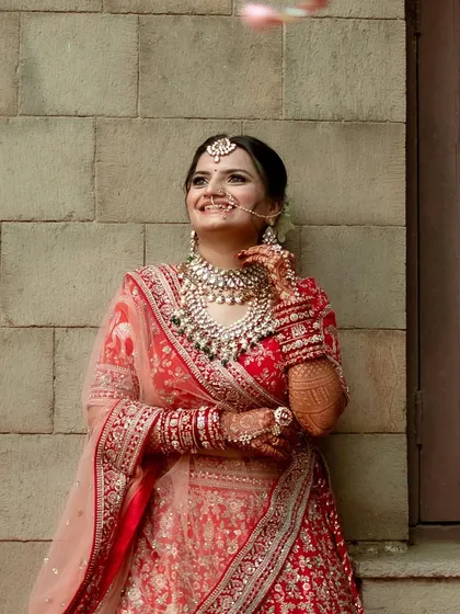 This bride wanted a royal wedding look, and we delivered. Dressed in a stunning red lehenga, her makeup was all about timeless elegance, perfect for a grand entrance.