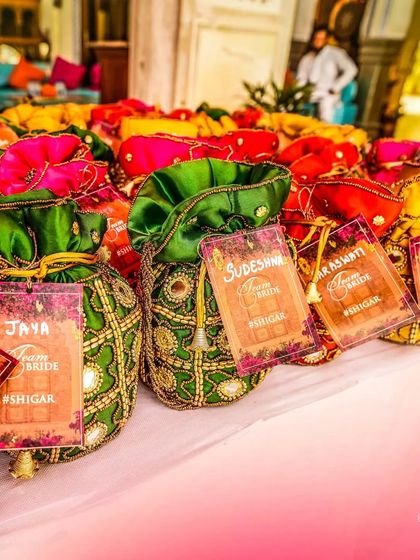 Colorful potli bags as wedding favors for the guests from 'Team Bride', a thoughtful and beautiful detail.