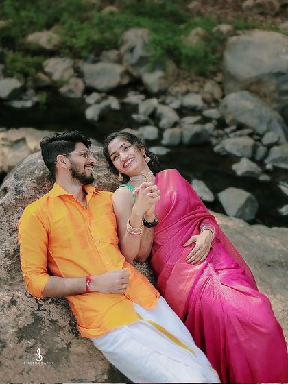 A playful and intimate moment, laughing together on the rocks. These are the genuine moments that make the best memories.
