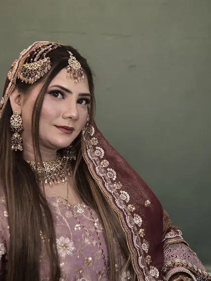 A portrait of an engagement bride in a lovely lavender outfit. The makeup is kept soft and romantic to match the occasion.