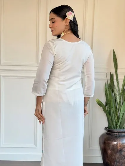 This off-white viscose chanderi kurta is a classic. The delicate embroidery and printed floral dupatta in shades of blue add a touch of color and grace.