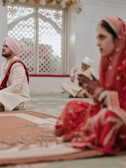 A candid moment during the Anand Karaj, showing the bride and groom in quiet contemplation.