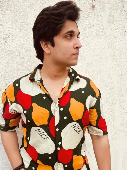 An outdoor shot featuring a colorful shirt. The natural lighting gives it a different feel from the studio shots, showing my adaptability to different environments.