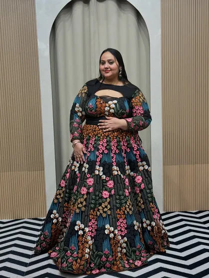 A full-length view of the floral embroidered plus-size lehenga. The A-line skirt is flattering for all body types, and the vibrant colors are perfect for a festive occasion.