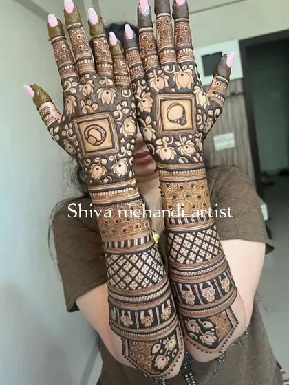 A unique design featuring a cricket bat and ball inside a frame, showing how a couple's shared interests can be part of their bridal mehendi.