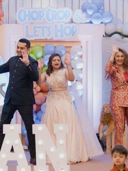 The parents and host dancing and celebrating at the Mundan party.