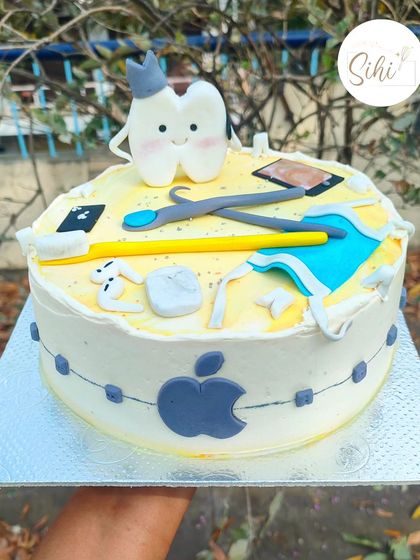 This cake was for a dentist who is also an Apple fanatic. It combines a cute tooth character and dental tools with the Apple logo and products, all made from fondant.