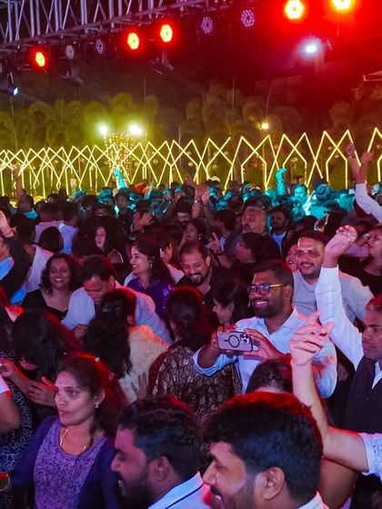 Look at that energy. A wide shot of the massive crowd for a New Year's Eve event, with everyone dancing and fully engaged. I ensure every corner of the venue feels the vibe.