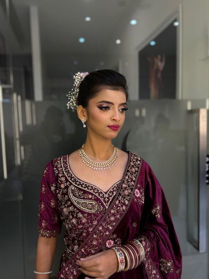 The full bridal look, showcasing the intricate velvet lehenga and perfectly coordinated makeup. Our students learn to create a harmonious and elegant bridal aesthetic.