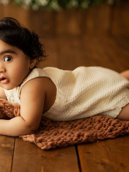 A tummy-time pose that shows off their strength and big, beautiful eyes.