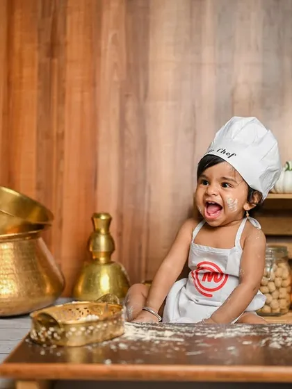 Let's get messy! A 'Little Chef' theme is a super fun idea for a first birthday or sitter session. It's all about capturing their playful spirit and adorable expressions.