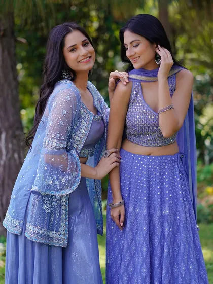 Two models sharing a lighthearted moment in complementary lavender outfits. This shot captures a genuine connection, making the fashion feel accessible and perfect for a lookbook aimed at friends or bridesmaids.