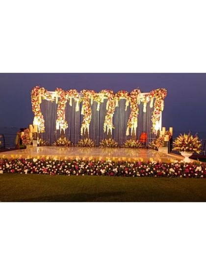 Another angle of the stunning seaside reception stage. The design is grand and luxurious, perfect for a large-scale celebration with a view.