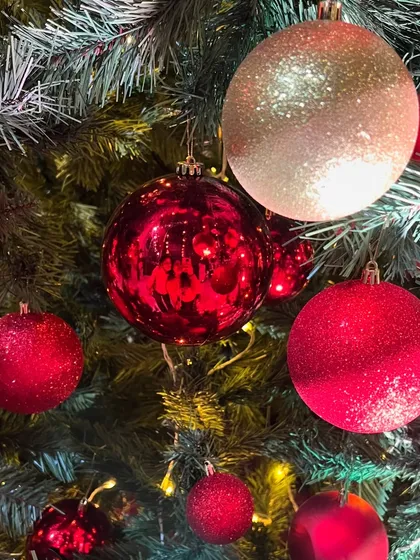 Detail is key, even in large installations. This shot highlights the classic red and shimmering gold ornaments that adorned the tree, creating a rich texture and catching the light beautifully.