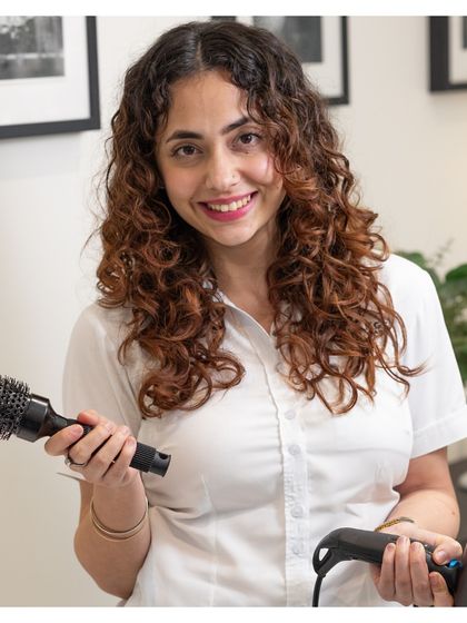 Our top stylist, Parteet, is ready to create your next look. Our team members are not just technicians; they are artists.