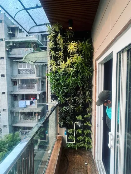 Our team member performs a final check on the vertical garden installation. We ensure every plant is perfectly placed and the irrigation system is functioning correctly.